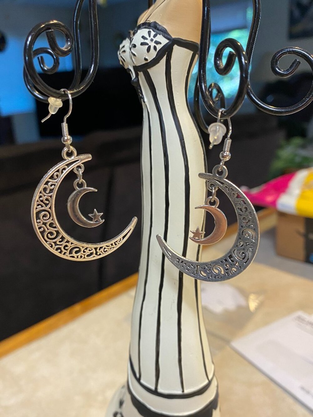 Silver tone moon earrings w/sun & moon inside.